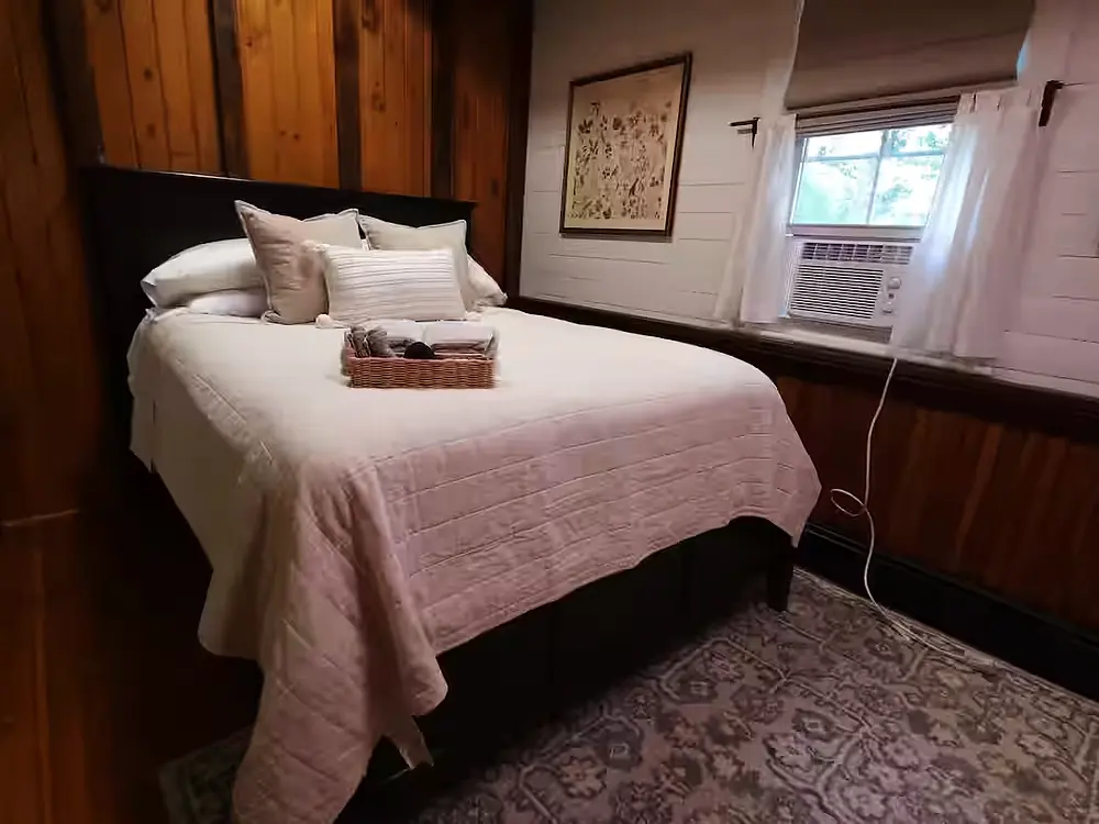 Queen bed with window in background